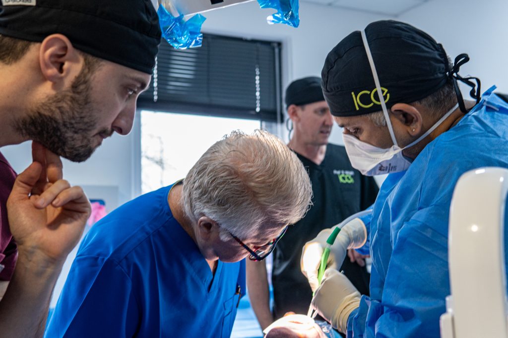 Postgraduate dental students treating a patient under clinical supervision at ICE Dental Institute & Hospital in Manchester.